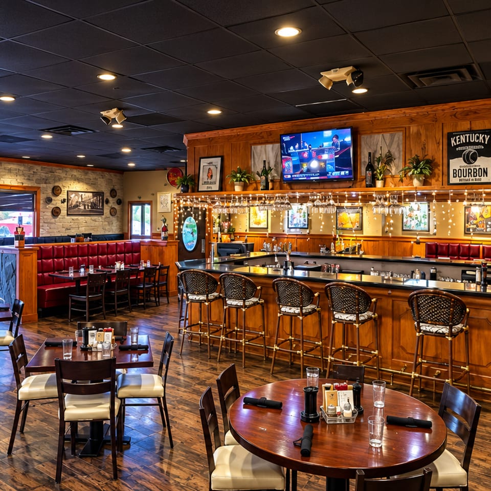 Restaurant dining room with tables, booths, and seating around a central bar.